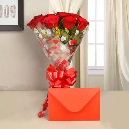 bunch of 10 red roses in a paper packing and a greeting card